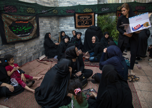 Iranian shiite women share tea and cakes in a private house for nazri during Chehel Manbar festival on Tasua to commemorate the martyrdom anniversary of Hussein, Lorestan Province, Khorramaba