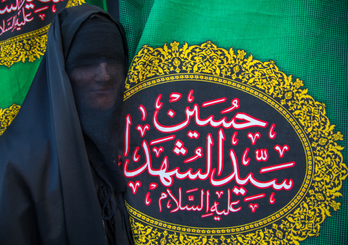 Iranian shiite muslim woman mourning Imam Hussein on the day of Tasua with her face covered by a veil, Lorestan Province, Khorramabad, Iran