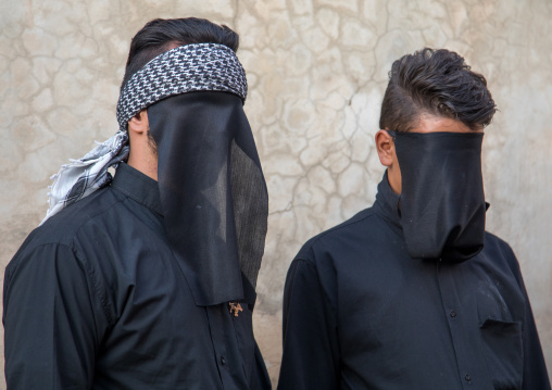 Portrait of iranian shiite muslim men with their faces hidden by a veil mourning Imam Hussein on Tasua during the Chehel Manbar ceremony one day before Ashura, Lorestan Province, Khorramabad,