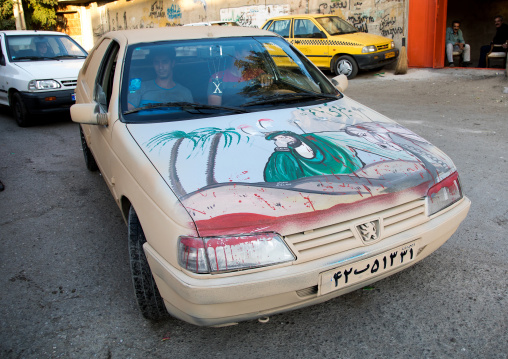 The portrait of Imam Hussein on a Peugeot car covered with mud for Ashura commemoration, Lorestan Province, Khorramabad, Iran