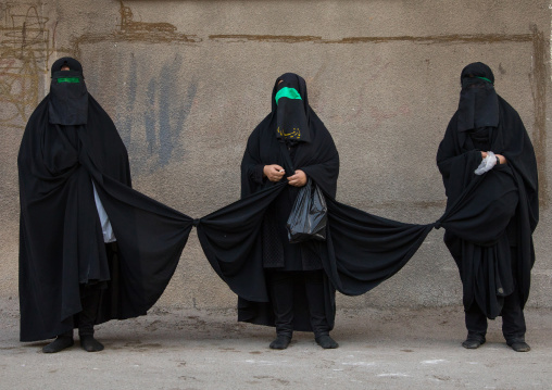 Portrait of three iranian shiite women with knotted veils to walk together in sacred spots during the fourty pulpit ceremony a day before Ashura, Lorestan Province, Khorramabad, Iran