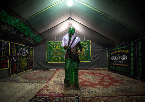 Man inside a tent and dressed as Imam Hussein during Ashura commemoration, Lorestan Province, Khorramabad, Iran