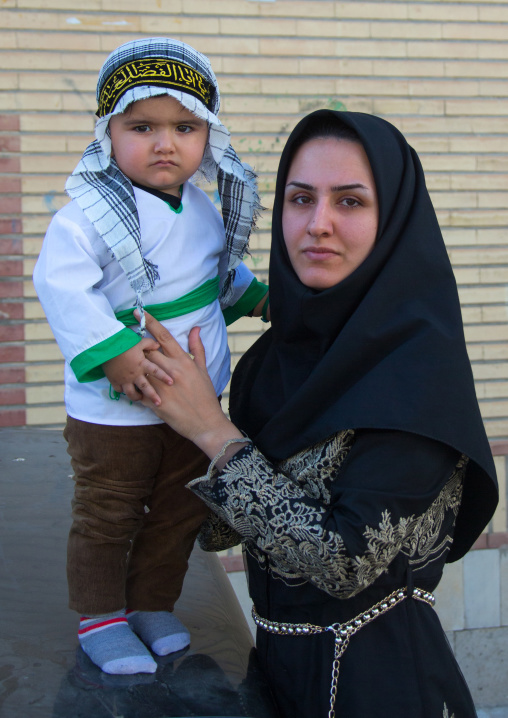 Iranian shiite muslim child dressed for Muharram with his mother, Lorestan Province, Khorramabad, Iran