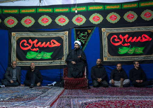 Iranian shiite muslim men listening to a Mullah who preaches during Muharram, Central County, Theran, Iran