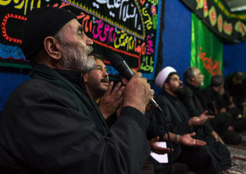 Iranian shiite muslim men listening to a Mullah who preaches during Muharram, Central County, Theran, Iran