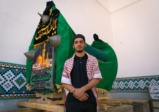 Portrait of a shiite man in front of a nakhl in the Shrine of sultan Ali during Muharram, Kashan County, Mashhad-e Ardahal, Iran