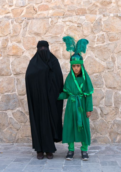 Shhite iranian mother and her son in costume to celebrate Muharram, Lorestan Province, Khorramabad, Iran