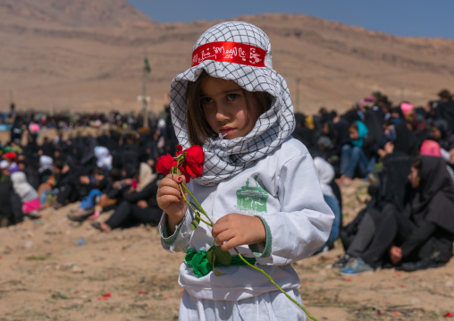 Iranian boy with a rose during a traditional religious theatre called tazieh about Imam Hussein death in Kerbala, Lorestan Province, Khorramabad, Iran
