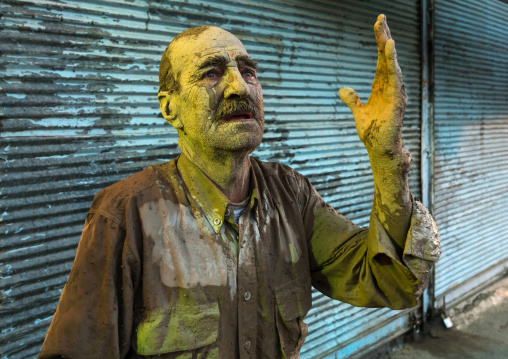 Iranian shiite muslim man crying after rubbing mud on his body during the Kharrah Mali ritual to mark the Ashura ceremony, Lorestan Province, Khorramabad, Iran