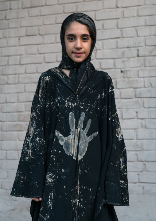 Iranian shiite muslim young woman with a handprint on her clothes during the Kharrah Mali ritual to mark the Ashura ceremony, Lorestan Province, Khorramabad, Iran