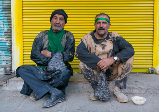 Portrait of two iranian shiite muslim men who eat their breakfast after rubbing mud on their bodies early in the morning, Lorestan Province, Khorramabad, Iran