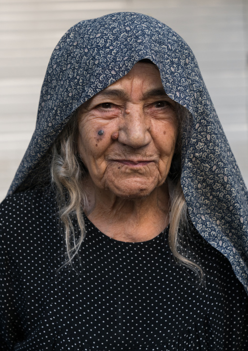 Iranian shiite muslim woman after rubbing mud on her clothes during the Kharrah Mali ritual to mark the Ashura ceremony, Lorestan Province, Khorramabad, Iran