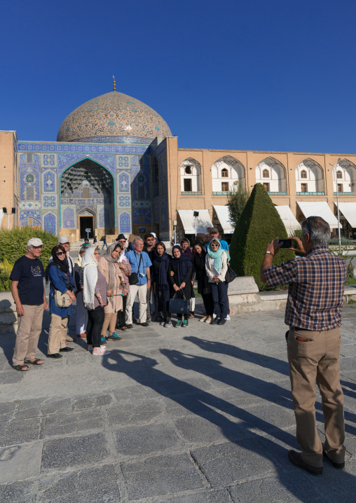 Tourists taking a photo souvenir in front of Sheikh Lutfollah Mosque on the eastern side of Naghsh-i Jahan Square, Isfahan Province, Isfahan, Iran