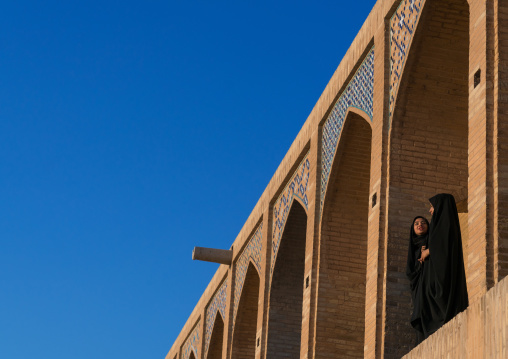 Two young veiled women on Khaju bridge Pol-e Khaju, Isfahan Province, Isfahan, Iran
