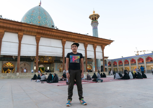 Iranian boy in front of the Mausoleum of Shah-e-Cheragh, Fars Province, Shiraz, Iran