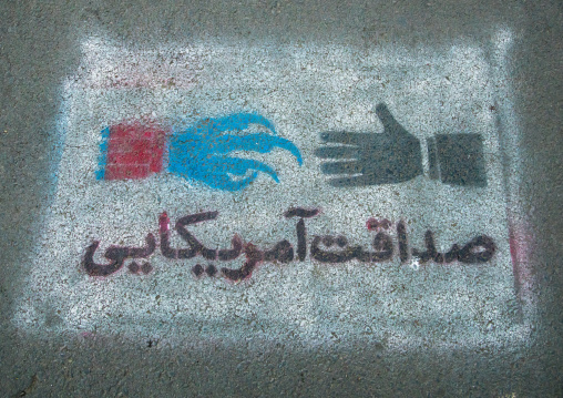 anti-american propoganda painting saying honesty and friendship of  america, on the pavement of of the former united states embassy, Central district, Tehran, Iran