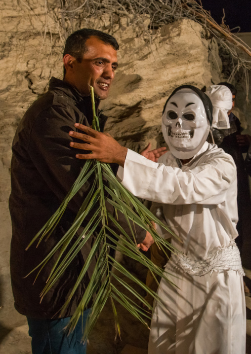 man wearing horror mask during a traditional wedding, Qeshm Island, Tabl , Iran
