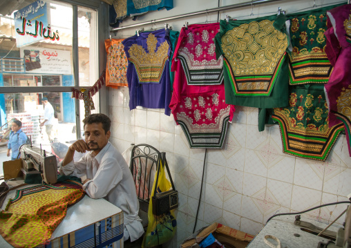 tailor using a sewing machine to make embroideries, Qeshm Island, Salakh, Iran