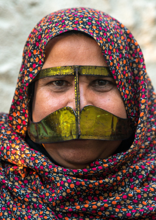 a bandari woman wearing a traditional gold mask called the burqa with a moustache shape, Qeshm Island, Salakh, Iran