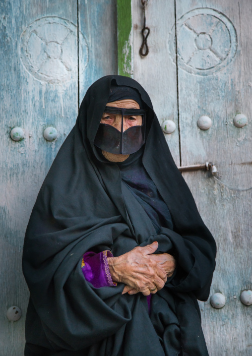 an old bandari woman wearing a traditional mask called the burqa, Qeshm Island, Salakh, Iran