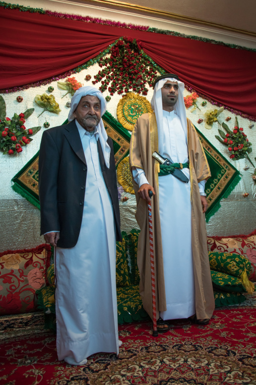 groom posing with his father in his new traditional clothes during a wedding ceremony, Hormozgan, Bandar-e Kong, Iran