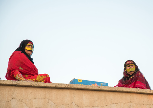 women with face masks throwing sweets to kids during a wedding, Hormozgan, Kushkenar, Iran