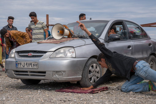 car rolling on the hand of a man, Hormozgan, Minab, Iran