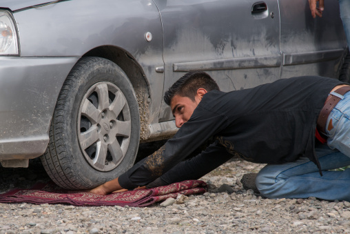 car rolling on the hand of a man, Hormozgan, Minab, Iran