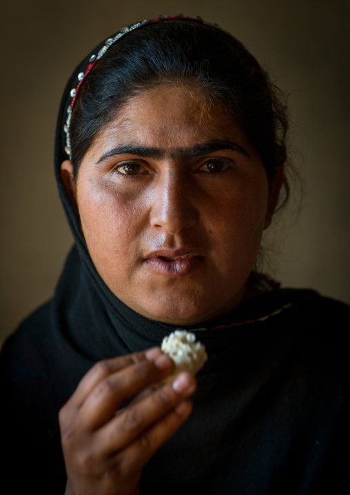 gypsy woman eating bread, Central County, Kerman, Iran
