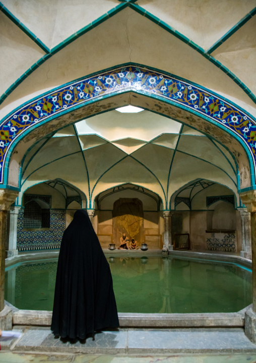 women in black inside ganjali khan hammam, Central County, Kerman, Iran