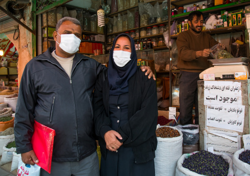 a couple wearing face masks to protect from h1n1 influenza in ganjali bazaar, Central County, Kerman, Iran