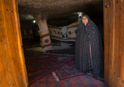 old widow woman inside the mosque of the troglodyte village, Kerman province, Meymand, Iran
