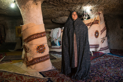 old widow woman inside the mosque of the troglodyte village, Kerman province, Meymand, Iran