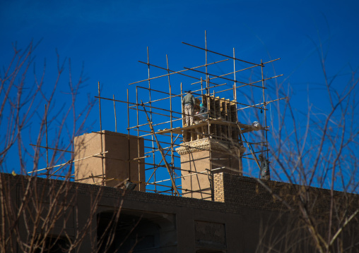 workers building of a wind tower in dolat abad garden, Central County, Yazd, Iran