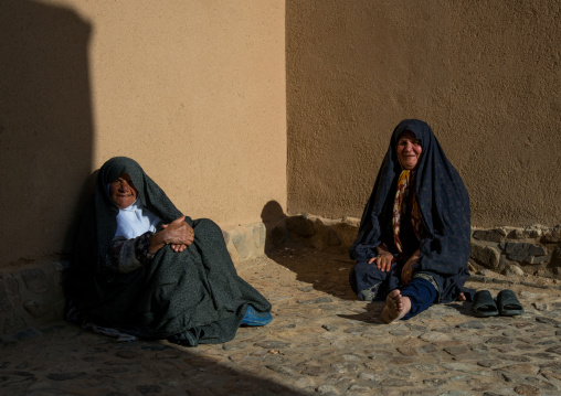 old women resting in a courtyard, Ardakan County, Aqda, Iran