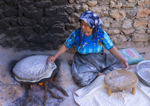 Woman Making Local Bread In The Old Kurdish Village Of Palangan At Dusk, Iran