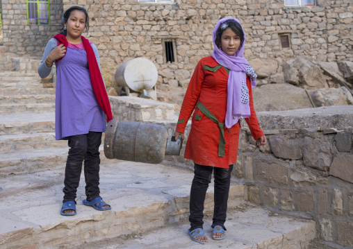 Girls Carrying A Gas Bottle In The Old Kurdish Village Of Palangan, Iran