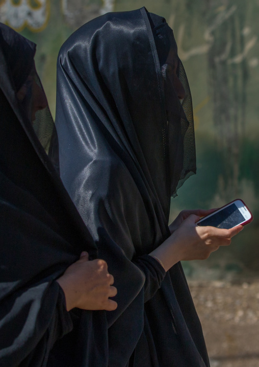 Iranian Shiite Muslim Woman With A Mobile Phone On The Day Of Tasua With Her Face Covered By A Veil, Lorestan Province, Khorramabad, Iran