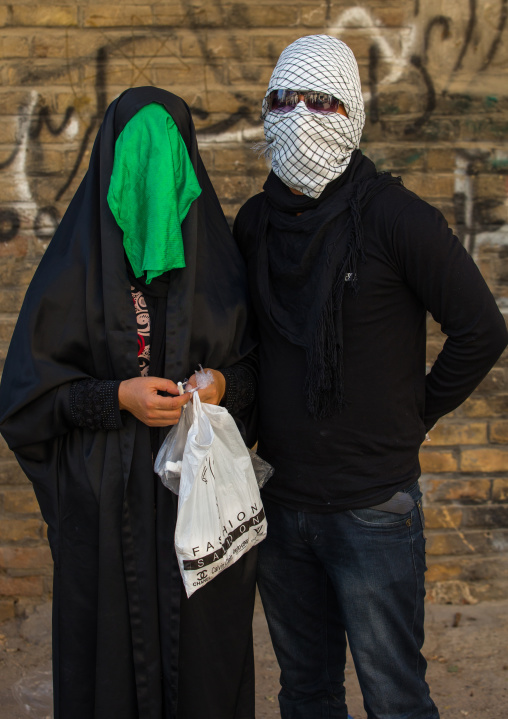 Iranian Shiite Muslim Couple Mourning Imam Hussein On The Day Of Tasua With Their Faces Covered By A Veil, Lorestan Province, Khorramabad, Iran
