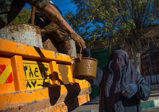 Iranian Shiite Muslim Woman Collecting A Bucket Full Of Mud During Ashura, The Day Of The Death Of Imam Hussein, Kurdistan Province, Bijar, Iran