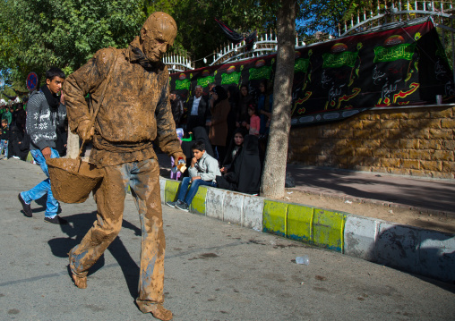 Iranian Shiite Muslim Man Covered In Mud With A Bucket During Ashura Day, Kurdistan Province, Bijar, Iran