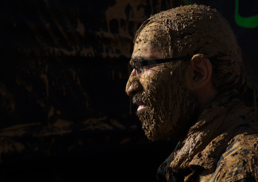 Iranian Shiite Muslim Man With Glasses Covered In Mud During Ashura Day, Kurdistan Province, Bijar, Iran