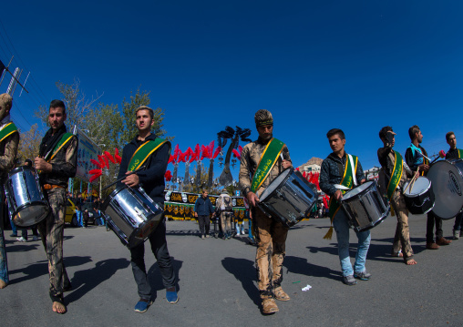 Iranian Shiite Muslim Men Playing Drums In Front Of An Alam During Ashura, The Day Of The Death Of Imam Hussein, Kurdistan Province, Bijar, Iran