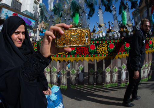 Iranian Woman Taking Pictures With A Mobile Phone Branded Louis Vuitton During Ashura, The Day Of The Death Of Imam Hussein, Kurdistan Province, Bijar, Iran