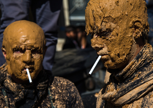 Iranian Shiite Muslim Men Covered In Mud Smoking Cigarettes During Ashura Day, Kurdistan Province, Bijar, Iran