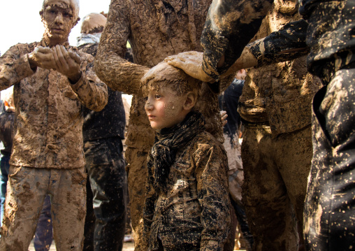 Iranian Shiite Muslim Boy Covered In Mud By Adults During Ashura Day, Kurdistan Province, Bijar, Iran
