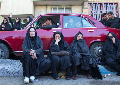 Iranian Shiite Muslim Women And Men Watching The Ashura Parade Inside A Red Car, The Day Of The Death Of Imam Hussein, Kurdistan Province, Bijar, Iran