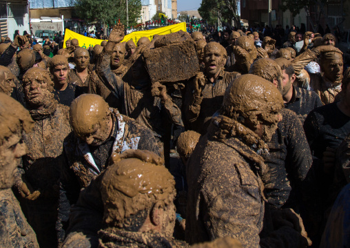 Iranian Shiite Muslim Men Covered In Mud Carrying A Coffin During Ashura, The Day Of The Death Of Imam Hussein, Kurdistan Province, Bijar, Iran