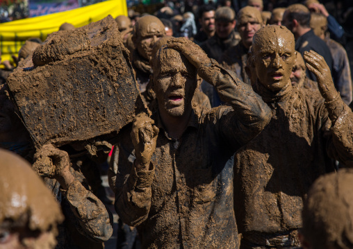 Iranian Shiite Muslim Men Covered In Mud Carrying A Coffin During Ashura, The Day Of The Death Of Imam Hussein, Kurdistan Province, Bijar, Iran