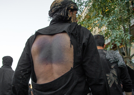 Iranian Shiite Man Covered In Mud Who Has Beaten Himself His Back With Iron Chains During Ashura, The Day Of The Death Of Imam Hussein, Kurdistan Province, Bijar, Iran